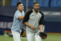 Tampa Bay Rays first baseman Ji-Man Choi, left, pats Nelson Cruz on the back during an American League Division Series baseball practice Wednesday, Oct. 6, 2021, in St. Petersburg, Fla. The Rays play the Boston Red Sox in the best-of-five series. (AP Photo/Chris O'Meara)