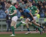 Ireland's Craig Gilroy runs on his way to score, vainly chased by Italy's Carlo Canna, during a Six Nations rugby union international match between Italy and Ireland at the Rome Olympic stadium, Saturday, Feb. 11, 2017. (AP Photo/Alessandra Tarantino)