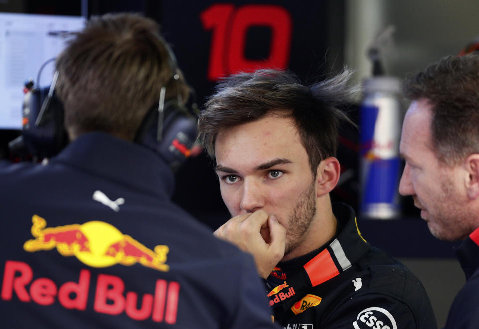 Red Bull driver Pierre Gasly of France, center, talks with team staff after crashing his car during a Formula One pre-season testing session at the Barcelona Catalunya racetrack in Montmelo, outside Barcelona, Spain, Tuesday, Feb.19, 2019. (AP Photo/Manu Fernandez)