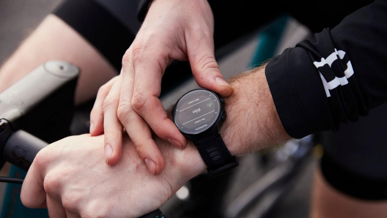 cyclist preparing for a ride and setting smart watch