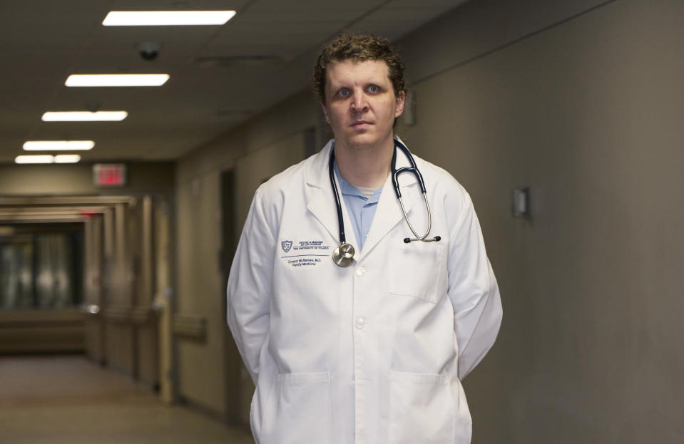 Dr. Connor McNamee, a third-year family medicine resident at the University of Toledo Medical Center, poses at the medical center, Tuesday, Oct. 18, 2022, in Toledo, Ohio. Students in obstetrics-gynecology and family medicine are facing tough choices about where to advance their training in a landscape where legal access to abortion varies from state to state. McNamee began exploring abortion training outside Ohio last summer. A state law bans most abortions after cardiac activity is detected, but a judge has blocked it while a challenge proceeds. (AP Photo/Rick Osentoski)