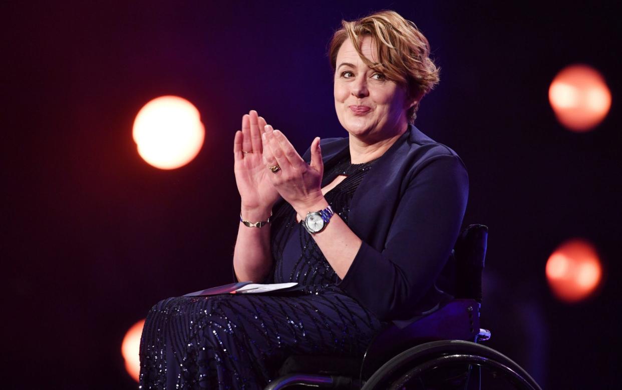 Tanni Grey-Thompson in a wheelchair, applauding at an event in Monaco