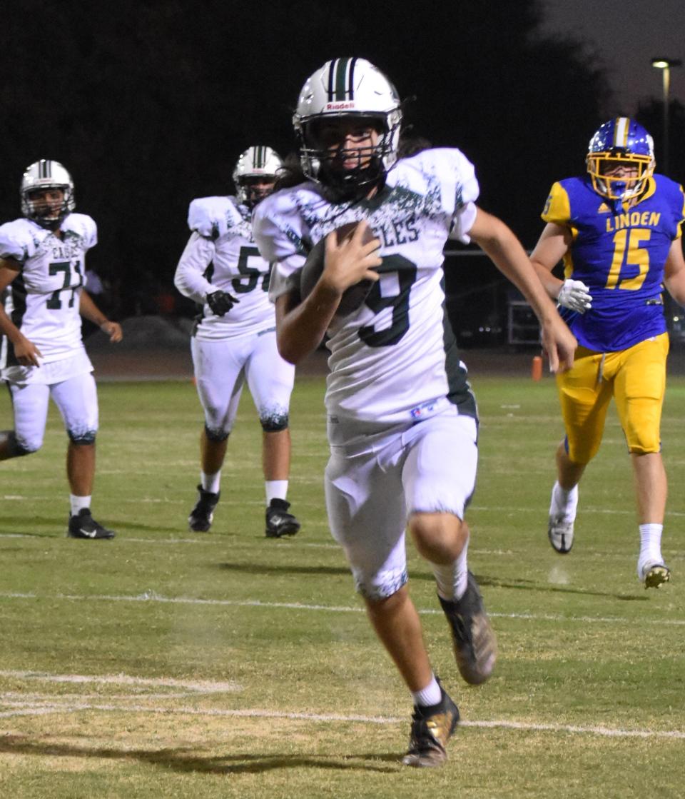 McNair sophomore quarterback Skyler Bell outraces the Linden defense to the pylon for a 17-yard touchdown in their SJAA tilt Friday night at Lion Stadium.