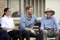 Britain's Prince Harry and Meghan, Duchess of Sussex sit down with the Woodleys family during a farm visit in Dubbo, Australia, Wednesday, Oct. 17, 2018. Prince Harry and his wife Meghan are on day two of their 16-day tour of Australia and the South Pacific. (Chris Jackson/Pool via AP)