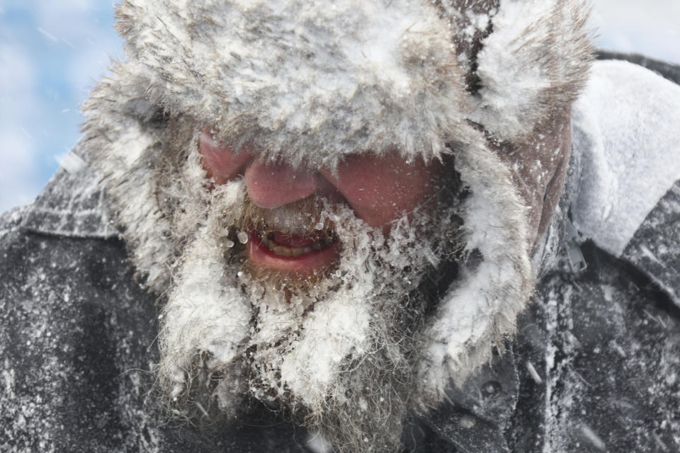 A worker helps remove snow from Highmark Stadium in Orchard Park, N.Y., Sunday Jan. 14, 2024. (AP Photo/ Jeffrey T. Barnes)