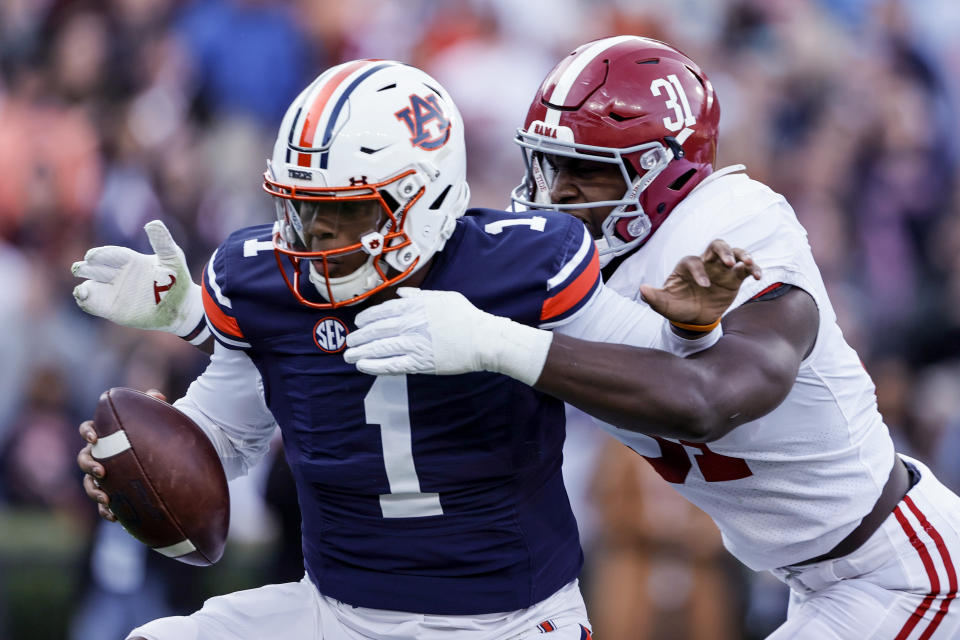 Alabama linebacker Will Anderson Jr. (31) sacks Auburn quarterback TJ Finley (1) during the first half of an NCAA college football game Saturday, Nov. 27, 2021, in Auburn, Ala. (AP Photo/Butch Dill)