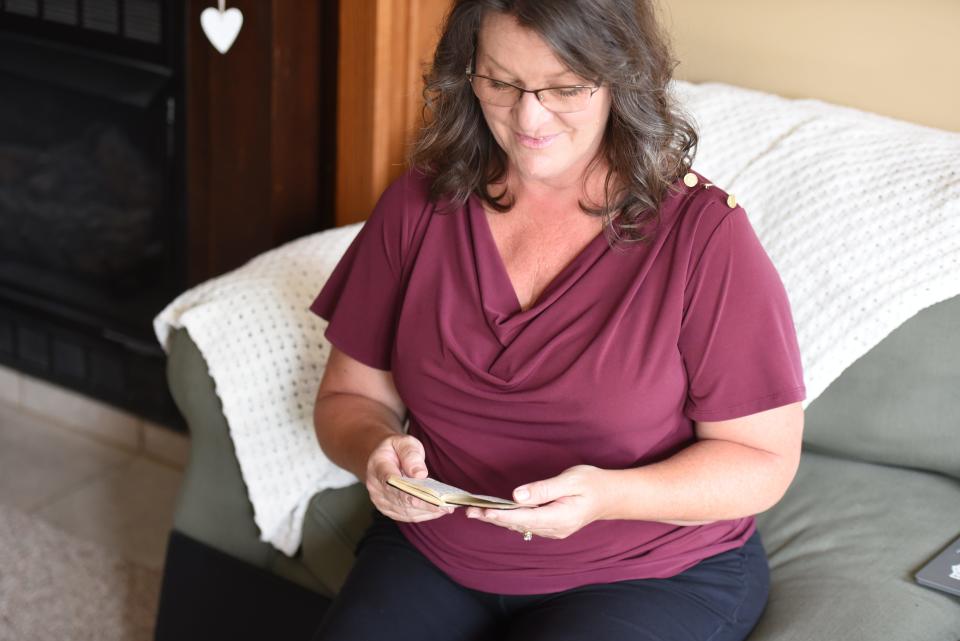 Susan Tetreau looks through her father's notebook on Aug. 22, 2023. Raymond Somogy kept notes on his experience in Vietnam, which proved vital to Tetreau's book.