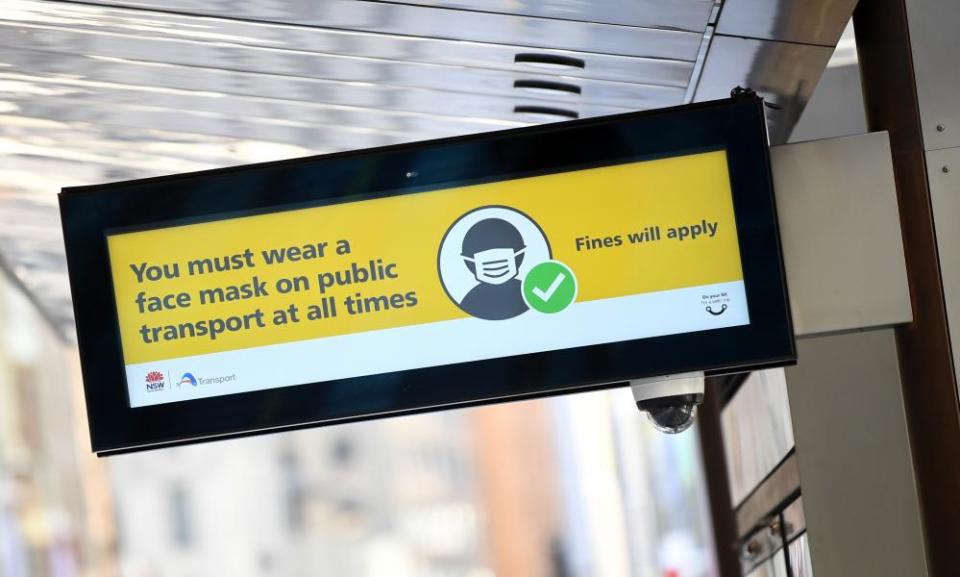 A sign on a light rail service in Sydney on 18 January warns passengers to wear a face mask.