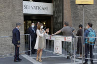 Vatican Museum director Barbara Jatta, center, stands outside the museum entrance to welcome back the first visitors on the museum's reopening date, in Rome, Monday, June 1, 2020. The Vatican Museums reopened Monday to visitors after three months of shutdown following COVID-19 containment measures. (AP Photo/Alessandra Tarantino)