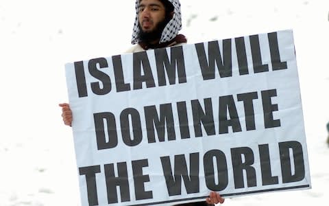 Usman Khan displays a placard at a weekly rally held by Islamic extremists in Burslem, Stoke-on-Trent, Staffordshire, in January 2010 - Credit: Stoke Sentinel&nbsp;