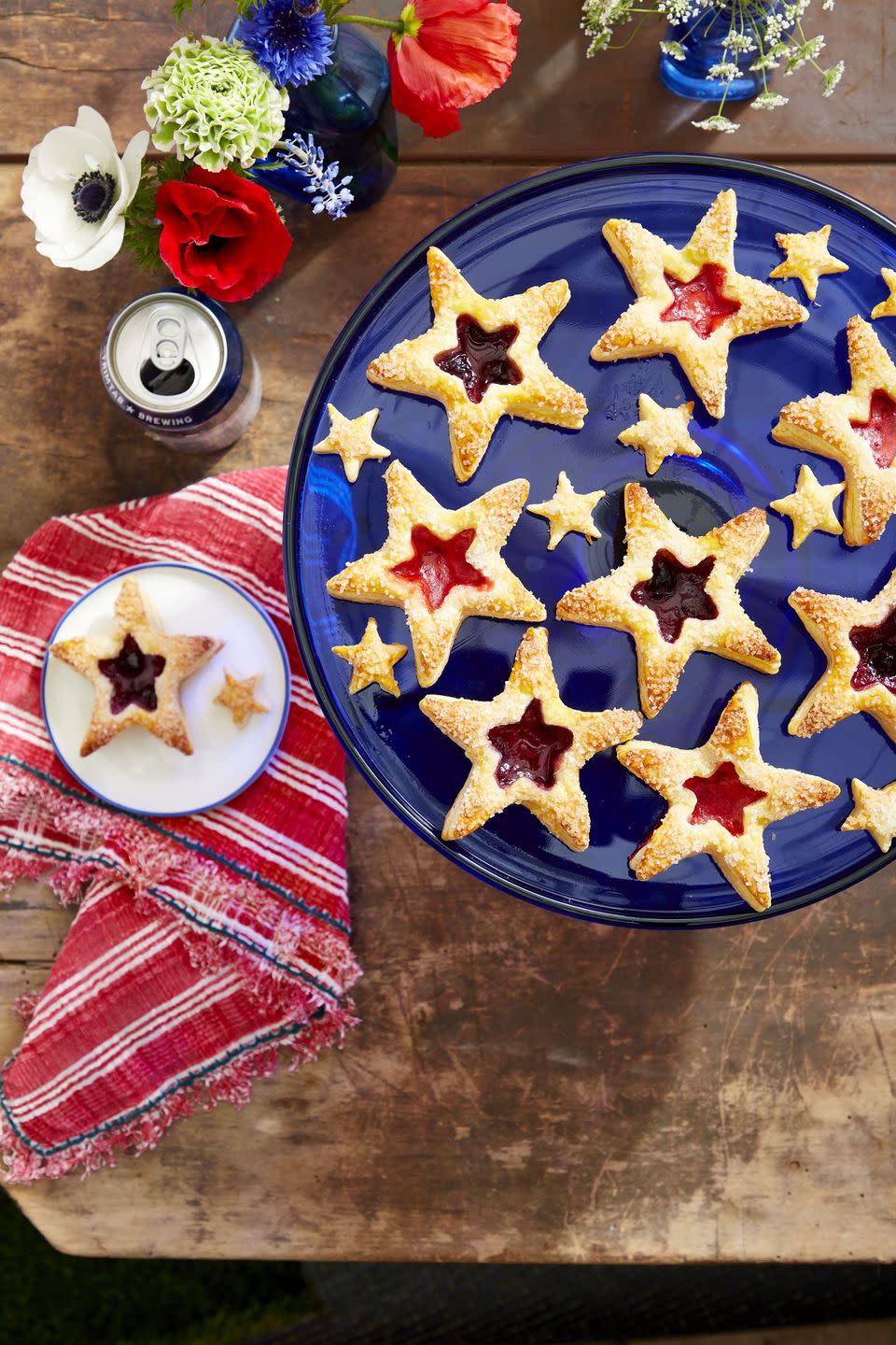 puff pastry star cookies with jam fillings in the centers and arranged on a blue cake stand