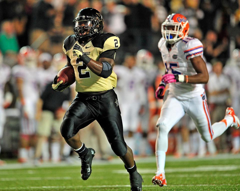 Vanderbilt Commodores running back Zac Stacy (2) runs past Florida Gators defensive back Loucheiz Purifoy for a touchdown during the third quarter in Nashville, Tenn., Saturday, Oct. 13, 2012. Vanderbilt lost 17-31. The play was nullified due to a Vanderbilt's holding penalty.