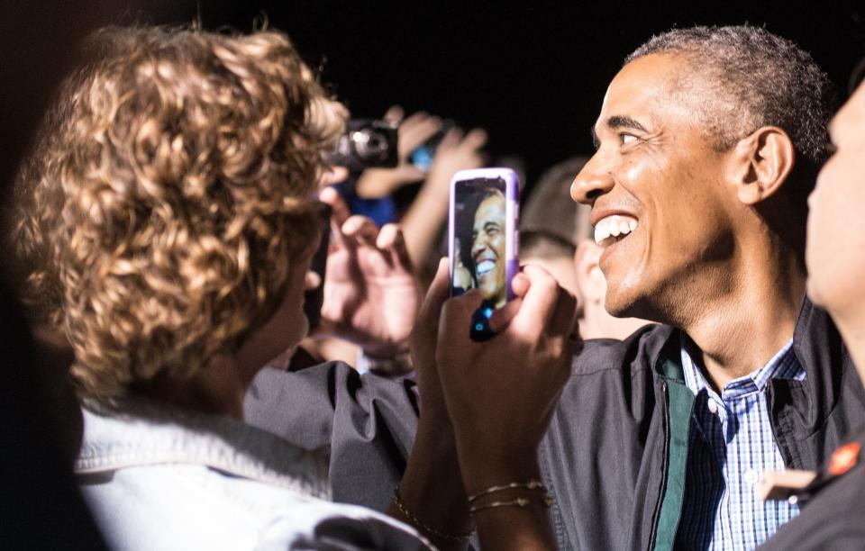 President Barack Obama greets well-wishers before boarding Air Force One at Cape Cod Coast Guard Air Station in Massachusetts on August 24, 2014, as he departs Martha's Vineyard.