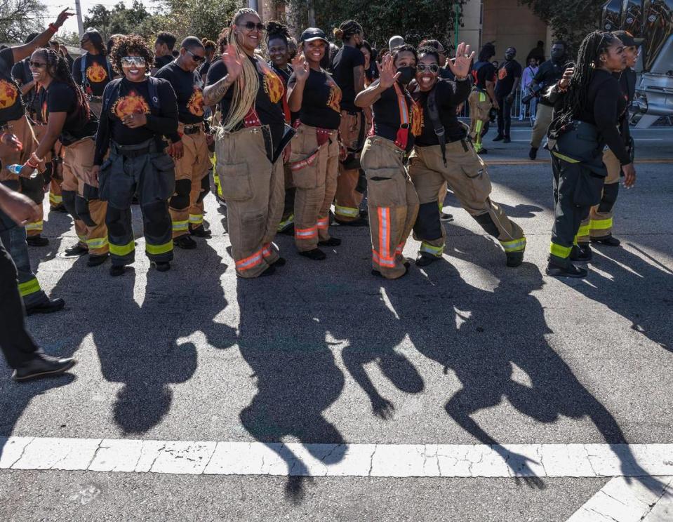 Black Miami-Dade Fire Rescue first responders wave to the crowd while they take a pause during the MLK parade in Miami. The 45th Annual MLK Parade traveled westbound on Northwest 54th Street starting on 12th Avenue featuring college and high school marching bands, politicians, City of Miami mounted police and motor units, police color guards, city and county fire/rescue trucks, Miami-Dade transit workers, and others on Monday, Martin Luther King Jr. Day, Jan. 17, 2022.