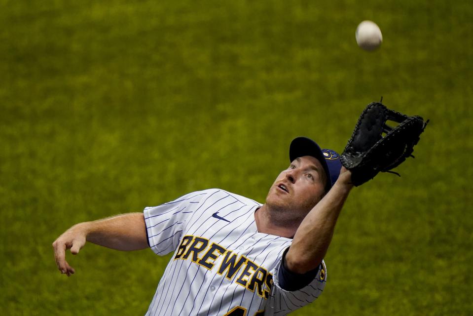 Milwaukee Brewers' Jedd Gyorko catches a foul ball hit by Pittsburgh Pirates' Erik Gonzalez during the third inning of a baseball game Friday, Aug. 28, 2020, in Milwaukee. (AP Photo/Morry Gash)