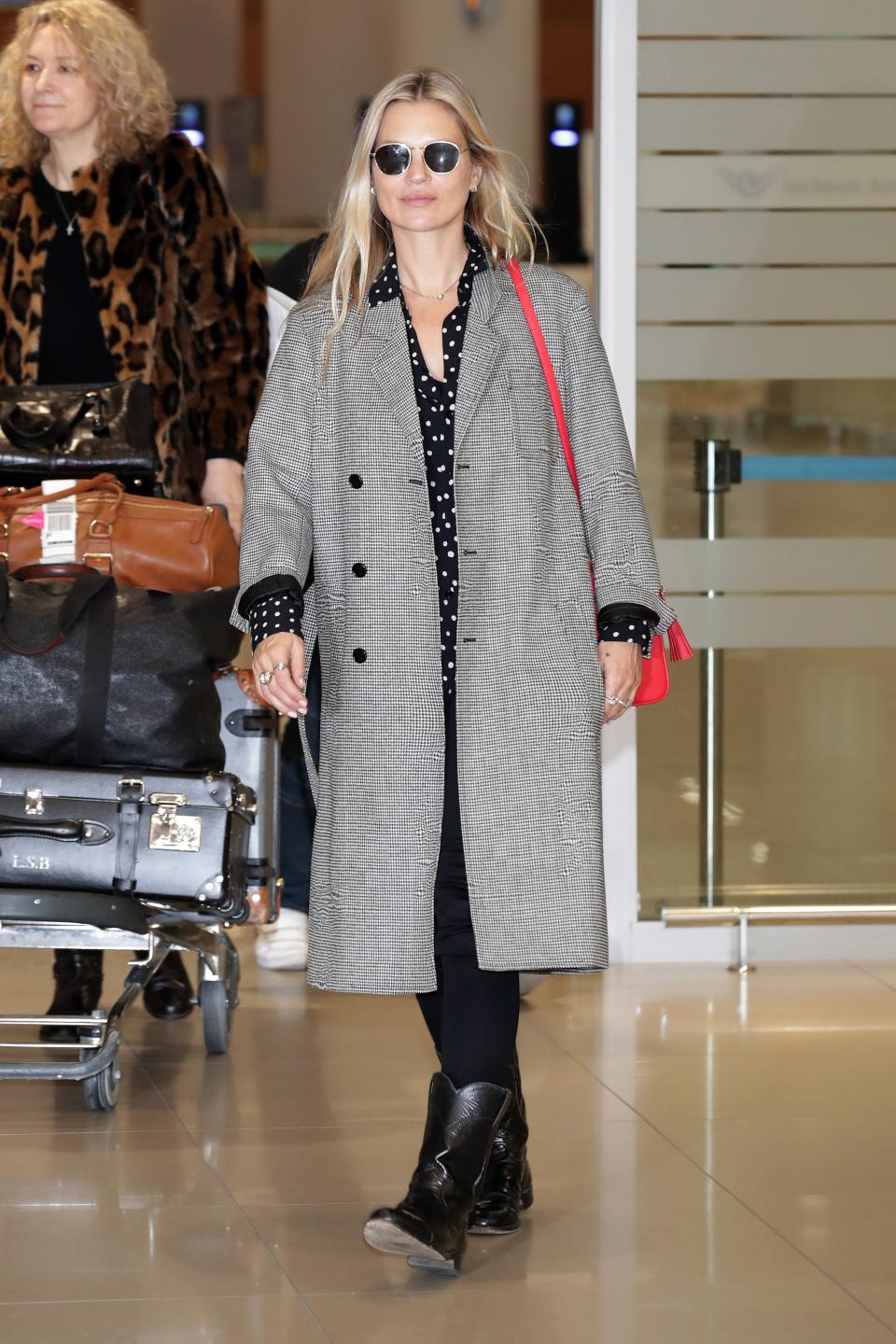 The supermodel touched down in South Korea in travel-friendly cowboy boots.