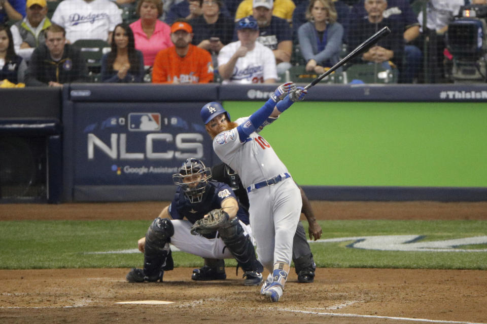 Los Angeles Dodgers' Justin Turner (10) hits a two-run home run during the eighth inning of Game 2 of the National League Championship Series baseball game against the Milwaukee Brewers Saturday, Oct. 13, 2018, in Milwaukee. (AP Photo/Charlie Riedel)