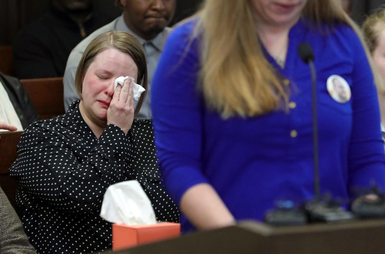Allison Kee-Jensen, widow of George "Geo" Jensen, wipes away tears as she listens to family members speak during Dacarrei Kinard's sentencing Friday for the shooting death of her late husband in Judge Kathryn Michael's courtroom in Akron.