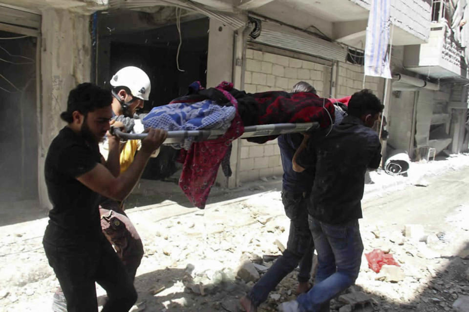 ADDS DATE --This photo provided by the Syrian Civil Defense White Helmets, which has been authenticated based on its contents and other AP reporting, shows Syrians carrying an injured person on a stretcher after an airstrike by Syrian government forces, in the town of Ariha, in the northwestern province of Idlib, Syria, Monday, May 27, 2019. Syria's White Helmets say at least six people were killed and 10 remain under rubble following government air raids on a town in the rebel's last stronghold. (Syrian Civil Defense White Helmets via AP)