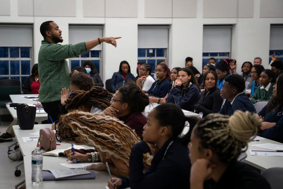 Demetrius Scott, director of corporate citizenship at Ally, speaks with students for a life skills and financial workshop during the Midnight Golf Program at Marygrove Conservancy in northwest Detroit, Tuesday, Feb. 7, 2023.