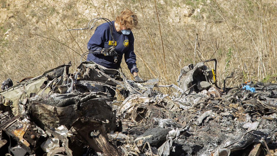 A National Transportation Safety Board investigator, pictured here at the scene of the helicopter crash.