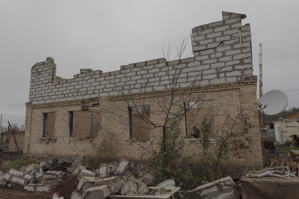 Vadym Zherdetsky stands in the remains of his house destroyed by fighting, in the village of Moshun, outside Kyiv, Ukraine, Friday, Nov. 4, 2022. When Russia invaded Ukraine in February, two missiles struck Zherdetsky's home in the tiny village of Moschun on the outskirts of the capital, Kyiv, ripping the roof off and nearly killing four of his family members. (AP Photo/Andrew Kravchenko)