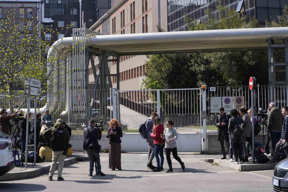 Reporters wait outside the San Raffaele hospital, in Milan, Italy, Wednesday, April 5, 2023. Ex-Premier Silvio Berlusconi was hospitalized Wednesday with apparent respiratory problems, Italian media reported. The 86-year-old three-time premier was in intensive care at Milan's San Raffaele hospital, the clinic where he routinely receives care, LaPresse news agency, Sky TG24 and Corriere della Sera reported, without citing sources.(AP Photo/Luca Bruno)