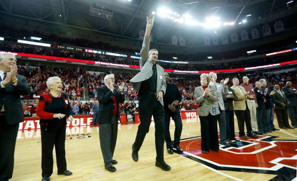 N.C. State’s Tommy Burleson acknowledges the crowd after being introduced as the 1974 National Champions Wolfpack are honored during halftime of N.C. State’s game against Miami at PNC Arena in Raleigh, N.C., Saturday, March 1, 2014.