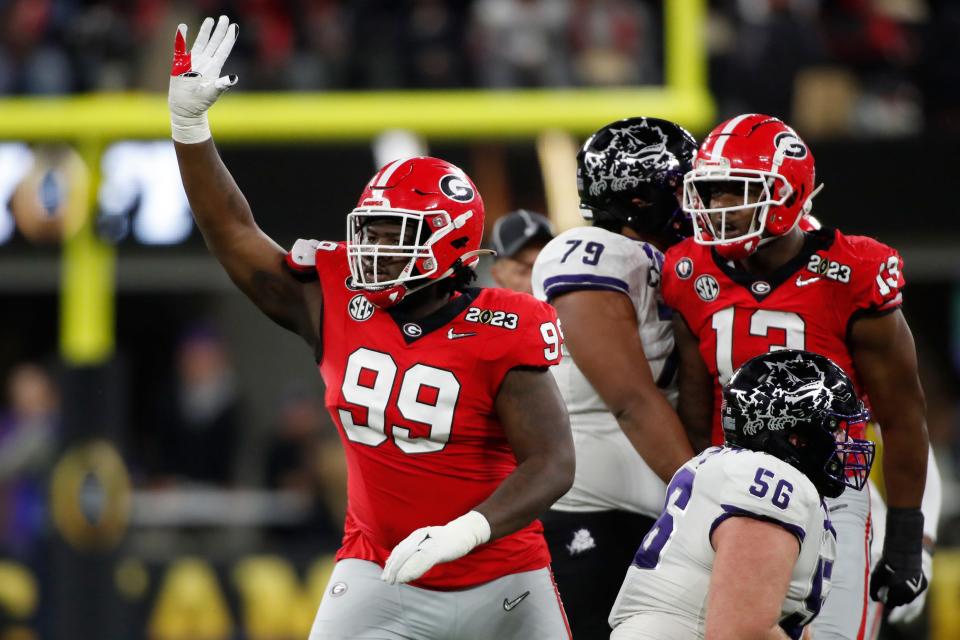 Georgia defensive lineman <a class="link " href="https://sports.yahoo.com/ncaaf/players/334635" data-i13n="sec:content-canvas;subsec:anchor_text;elm:context_link" data-ylk="slk:Bear Alexander;sec:content-canvas;subsec:anchor_text;elm:context_link;itc:0">Bear Alexander</a> (99) waves goodbye to the TCU fans after sacking TCU quarterback <a class="link " href="https://sports.yahoo.com/nfl/players/40272" data-i13n="sec:content-canvas;subsec:anchor_text;elm:context_link" data-ylk="slk:Max Duggan;sec:content-canvas;subsec:anchor_text;elm:context_link;itc:0">Max Duggan</a> (15) during the second half of the NCAA College Football National Championship game between TCU and Georgia on Monday, Jan. 9, 2023, in Inglewood, Calif.<br>News Joshua L Jones