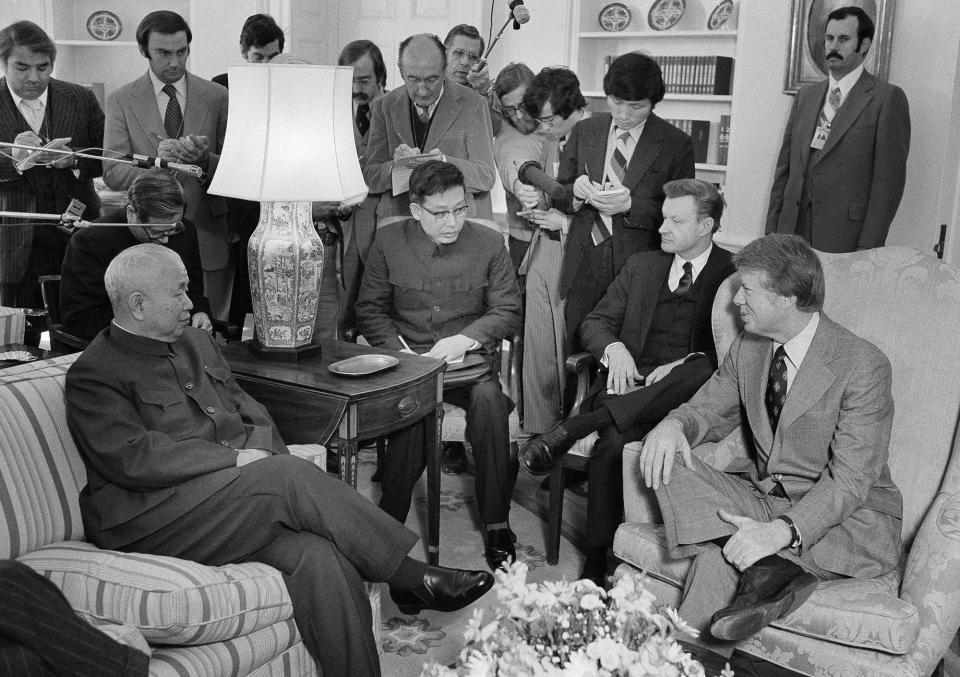 <p>Huang Chen, chief of the liaison office of the People’s Republic of China, left, meets with President Jimmy Carter in the Oval Office in Washington, Feb. 8, 1977. From left are Huang; Hsu Shan Wei, an interpreter; Zbigniew Brzezinski, national security advisor, and Carter. In the background are newsmen. (Photo: Harvey Georges/AP) </p>