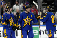 NHL All-Star Team Matthews captain forward Auston Matthews (34), of the Toronto Maple Leafs, and teammates Clayton Keller (9), of the Arizona Coyotes, and William Nylander (88), also of the Maple Leafs, celebrate after winning hockey's NHL All-Star Game against Team McDavid in Toronto, Saturday, Feb. 3, 2024. (Frank Gunn/The Canadian Press via AP)