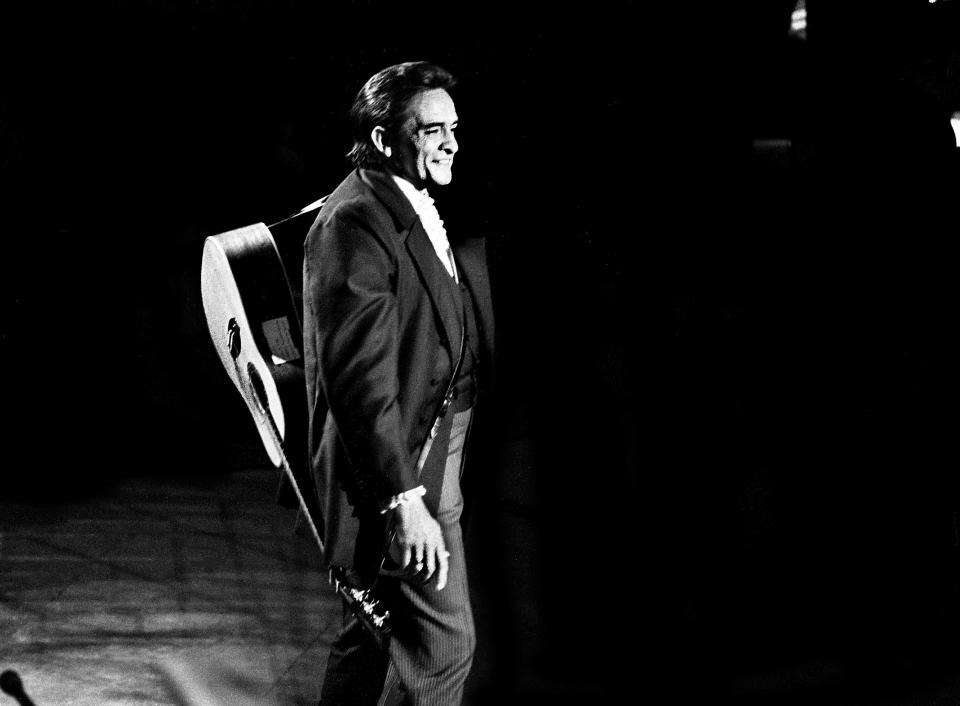 Host Johnny Cash shares a moment with the audience during the taping of 