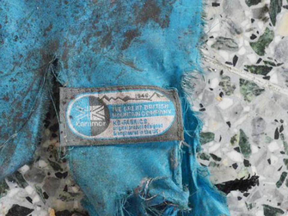 Remnants of a blue Karrimor backpack can be seen