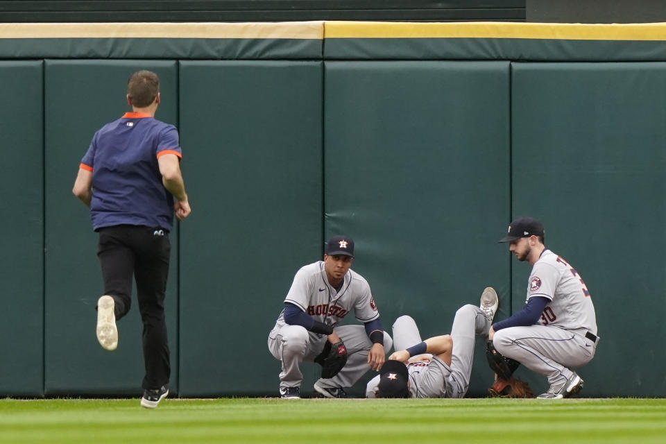 Houston Astros center fielder Jake Meyers is attended to by teammates after being injured against the Chicago White Sox in the second inning during Game 4 of a baseball American League Division Series Tuesday, Oct. 12, 2021, in Chicago. (AP Photo/Nam Y. Huh)