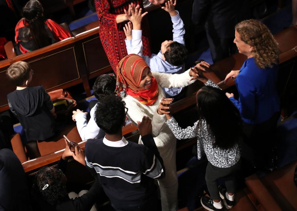 <p>Rep. Ilhan Omar celebrating after taking her oath of office.</p>