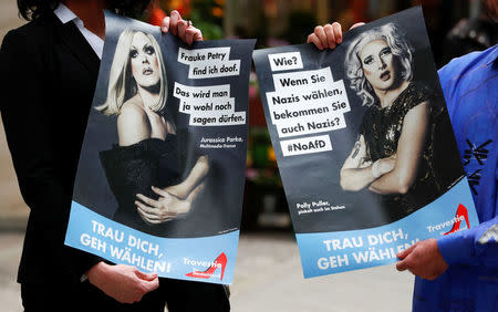 German drag artists Jacky-oh Weinhaus (L) and Buffalo Meus pose with posters as they parody the anti-Immigrant Alternative for Germany (AfD) party by setting up a fictional party called Travestie for Germany (TfD) in Berlin, Germany, August 24, 2017. REUTERS/Fabrizio Bensch