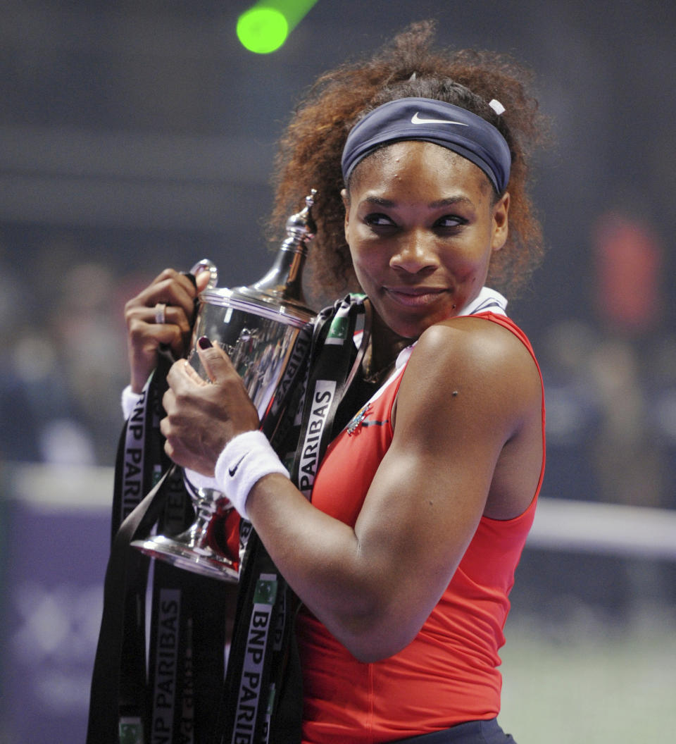 File-This Oct. 28, 2012, file photo shows Serena Williams of the U.S. holding her trophy after her tennis victory against Maria Sharapova of Russia on the final of the WTA Championships in Istanbul, Turkey. Williams has been voted the AP Female Athlete of the Decade for 2010 to 2019. Williams won 12 of her professional-era record 23 Grand Slam singles titles over the past 10 years. No other woman won more than three in that span. She also tied a record for most consecutive weeks ranked No. 1 and collected a tour-leading 37 titles in all during the decade. Gymnast Simone Biles finished second in the vote by AP member sports editors and AP beat writers. Swimmer Katie Ledecky was third, followed by ski racers Lindsey Vonn and Mikaela Shiffrin. (AP Photo/File)