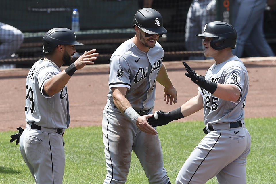 Chicago White Sox's Andrew Vaughn, right, is greeted by Adam Engel, center, and Leury Garcia after hitting a three-run home run against the Baltimore Orioles In the sixth inning of a baseball game, July 11, 2021, in Baltimore. All three scored on the hit. (AP Photo/Gail Burton)