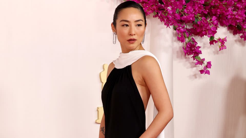 Greta Lee, styled by Danielle Goldberg, wore an elegant black and white Loewe gown. - Mike Coppola/Getty Images