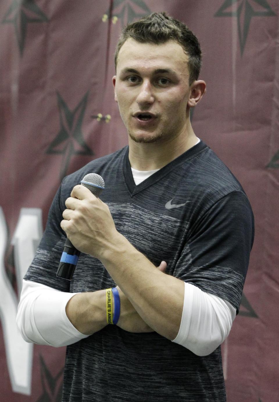 Texas A&M quarterback Johnny Manziel talks to members of the media during pro day for NFL football representatives in College Station, Texas, Thursday, March 27, 2014. (AP Photo/Patric Schneider)