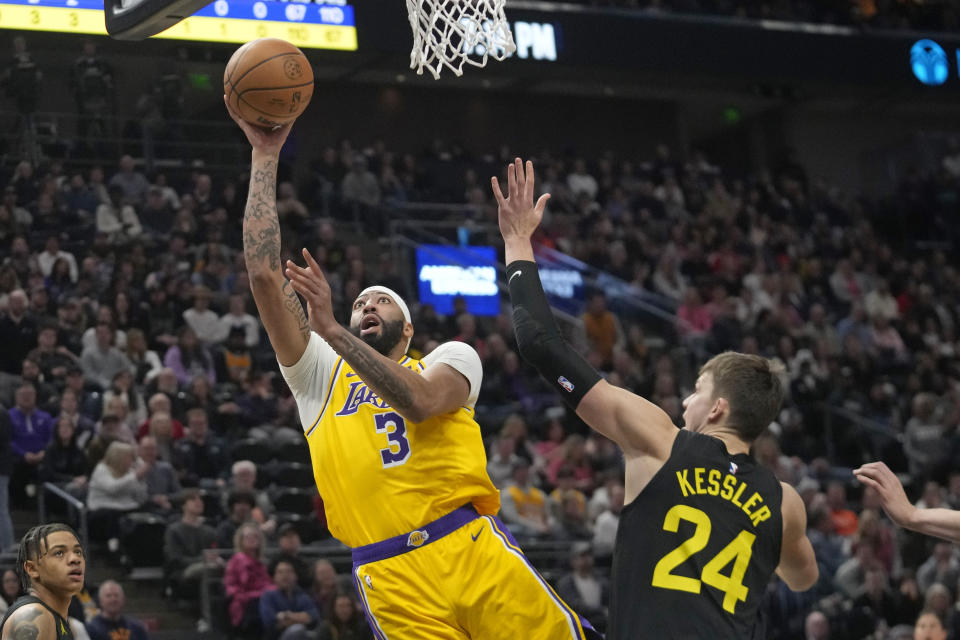 Los Angeles Lakers forward Anthony Davis (3) goes to the basket as Utah Jazz center Walker Kessler (24) defends during the first half of an NBA basketball game Wednesday, Feb. 14, 2024, in Salt Lake City. (AP Photo/Rick Bowmer)