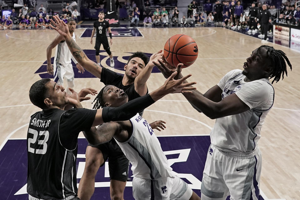 North Alabama forwards Tim Smith Jr. (23) and Damian Forrest, center battle for a rebound with Kansas State forwards Arthur Kaluma, right, and Macaleab Rich, front center, during the first half of an NCAA college basketball game Saturday, Dec. 2, 2023, in Manhattan, Kan. (AP Photo/Charlie Riedel)