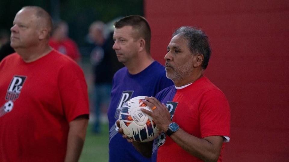 Alex Paz (right), Clay Smith (center) and John Moad (left) watch the kickoff during the inaugural “Paz Cup” in Granite City, Ill. on Oct 12., 2023. The Cup served as a fundraising event benefiting Paz, a local photographer with a community-wide reputation for covering athletics and other events who was recently diagnosed with cancer.