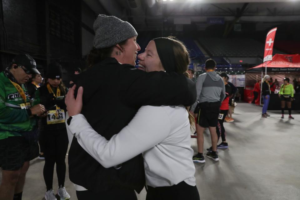 A competitor celebrates with a loved one after finishing the 2024 Michelob Ultra El Paso Marathon inside the El Paso County Coliseum on Sunday, Feb. 18. The race began at San Elizario High School.