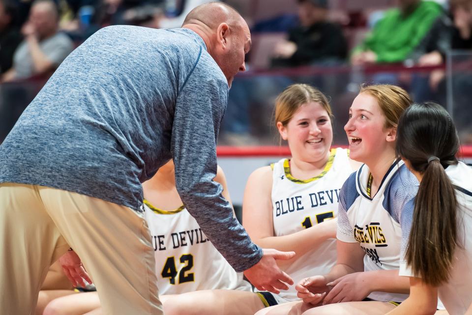Greencastle-Antrim senior Julia Herrmann (right) reacts as head coach Mike Rhine tells her she's going into the game during the District 3 Class 5A girls' basketball championship at the Giant Center on March 2, 2023, in Derry Township. The Blue Devils won, 44-30.