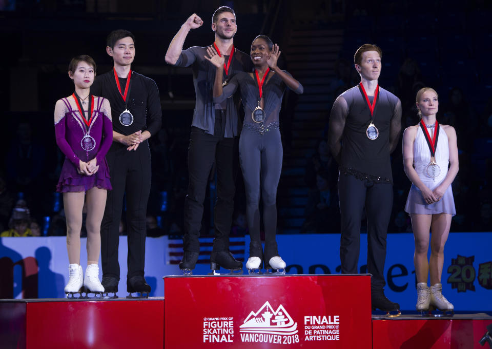 Gold medalists Vanessa James and Morgan Cipres, center, of France, stand on the podium with silver medalists Cheng Peng and Yang Jin, left, of China, and bronze medalists Evgenia Tarasova and Vladimir Morozov, of Russia, following the pairs free skate at figure skating's Grand Prix Final in Vancouver, British Columbia, Saturday, Dec. 8, 2018. (Jonathan Hayward/The Canadian Press via AP)