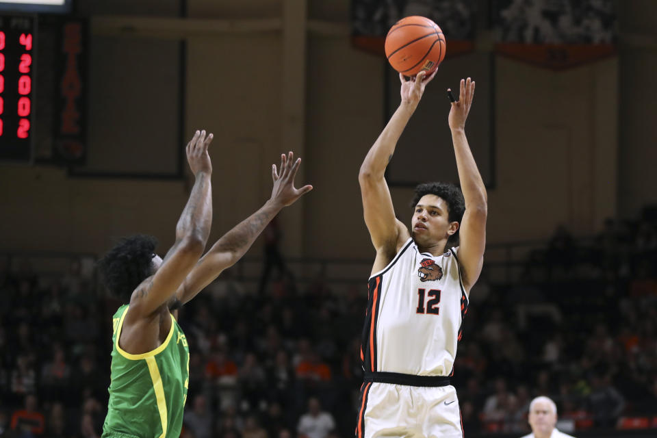 Oregon State forward Michael Rataj (12) shoots over Oregon guard Jermaine Couisnard (5) during the first half of an NCAA college basketball game Saturday, Feb. 17, 2024, in Corvallis, Ore. (AP Photo/Amanda Loman)