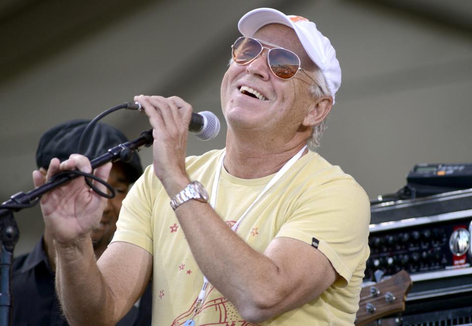 jimmy buffett smling and performing