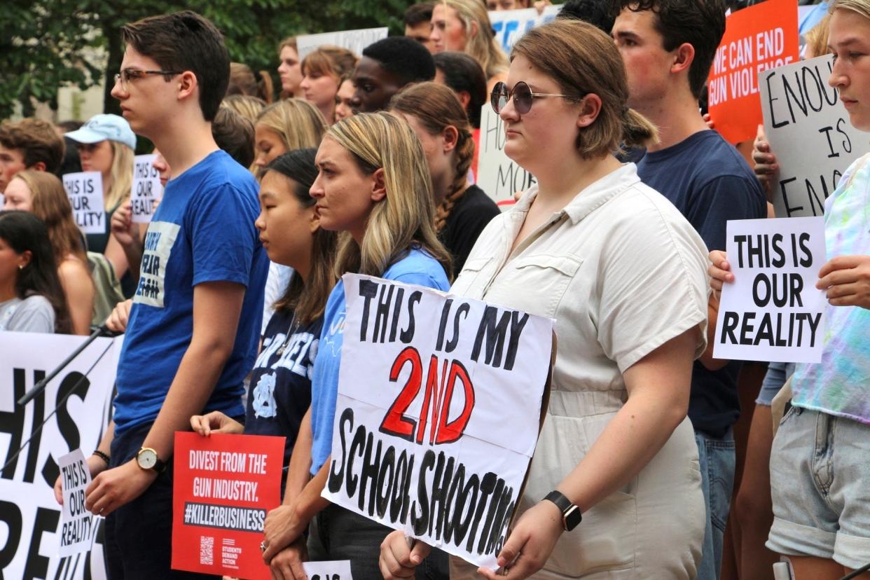 Students hold signs during a gun safety rally following a fatal shooting (AP)
