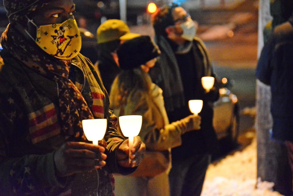 Participants in the candlelight walk for the Martin Luther King Jr. holiday circle up Monday outside of St. Luke United Methodist Church following their march from the Columbia Parks and Recreation Armory.